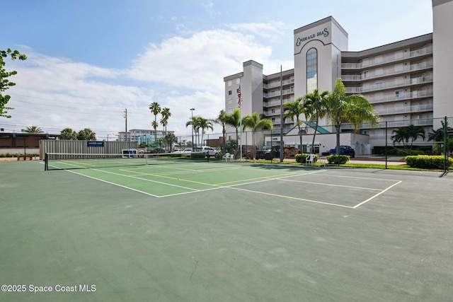 view of tennis court featuring fence and community basketball court
