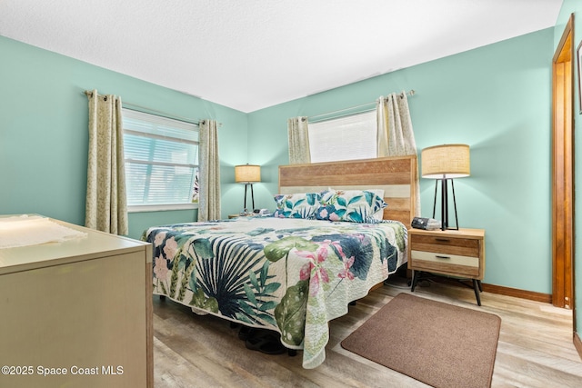 550 E Merrimac Dr, Merritt Island, FL 32952 - bedroom featuring wood finished floors and baseboards
