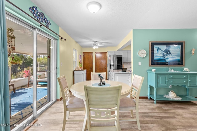 550 E Merrimac Dr, Merritt Island, FL 32952 - dining area featuring a ceiling fan, baseboards, light wood-type flooring, and a textured ceiling