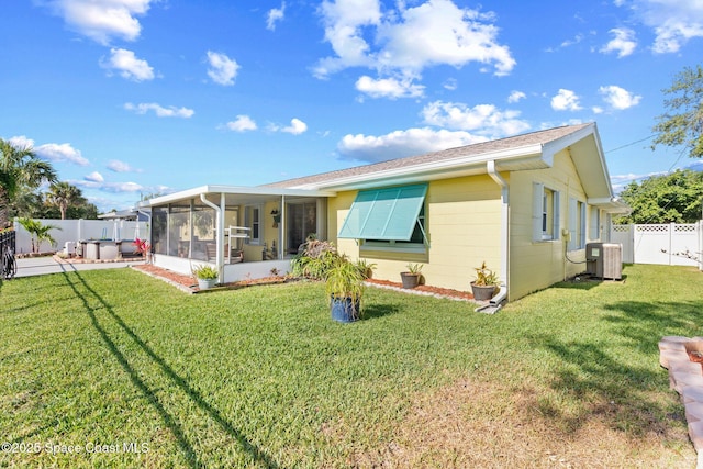 550 E Merrimac Dr, Merritt Island, FL 32952 - view of front of home with a sunroom, a fenced backyard, a front yard, and cooling unit