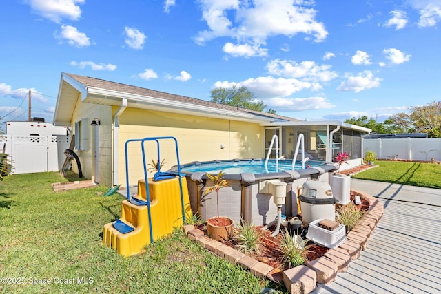 550 E Merrimac Dr, Merritt Island, FL 32952 - back of house featuring a yard, a sunroom, a fenced in pool, and a fenced backyard