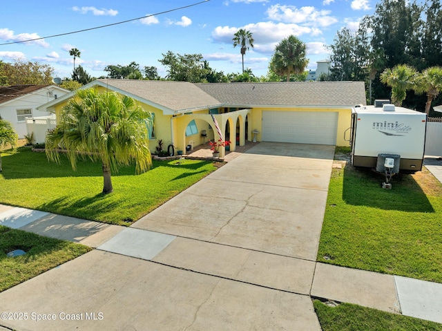 550 E Merrimac Dr, Merritt Island, FL 32952 - single story home with concrete driveway, a garage, stucco siding, and a front yard