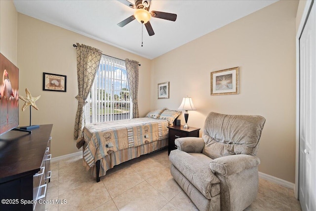 bedroom featuring baseboards, light tile patterned floors, and a ceiling fan