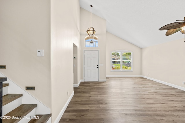 1050 Olde Bailey Ln, Melbourne, FL 32904 - foyer featuring a ceiling fan, wood finished floors, baseboards, stairway, and high vaulted ceiling