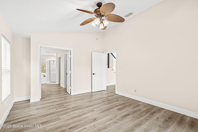 1050 Olde Bailey Ln, Melbourne, FL 32904 - unfurnished bedroom featuring light wood finished floors, vaulted ceiling, baseboards, and ceiling fan
