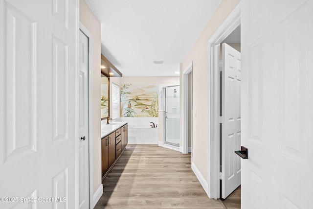 1050 Olde Bailey Ln, Melbourne, FL 32904 - full bathroom with a shower stall, vanity, a bath, wood finished floors, and baseboards