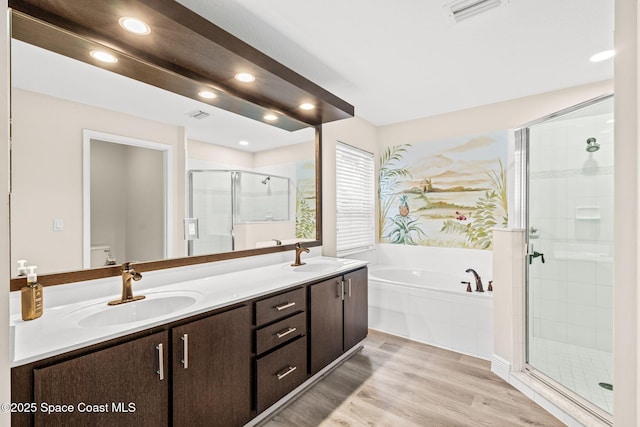 1050 Olde Bailey Ln, Melbourne, FL 32904 - bathroom featuring a garden tub, a stall shower, double vanity, recessed lighting, and toilet