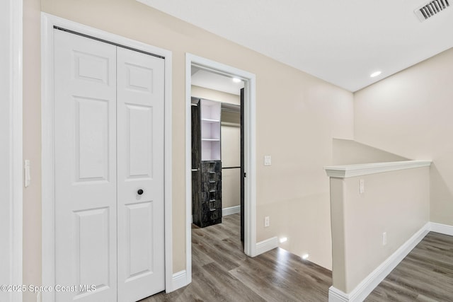 1050 Olde Bailey Ln, Melbourne, FL 32904 - hallway featuring an upstairs landing, baseboards, and wood finished floors