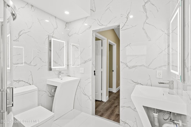 1050 Olde Bailey Ln, Melbourne, FL 32904 - bathroom with tile walls, toilet, wood finished floors, and recessed lighting