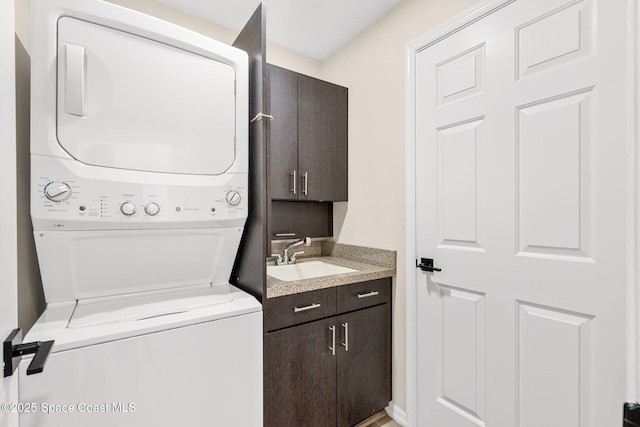 1050 Olde Bailey Ln, Melbourne, FL 32904 - washroom with stacked washer and clothes dryer and cabinet space