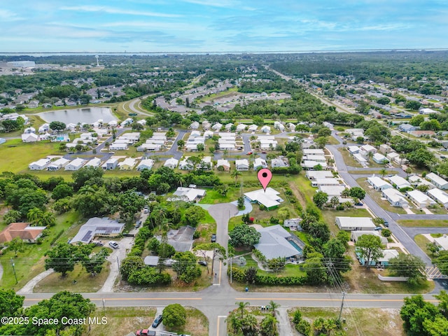aerial overview of property's location with nearby suburban area and a large body of water