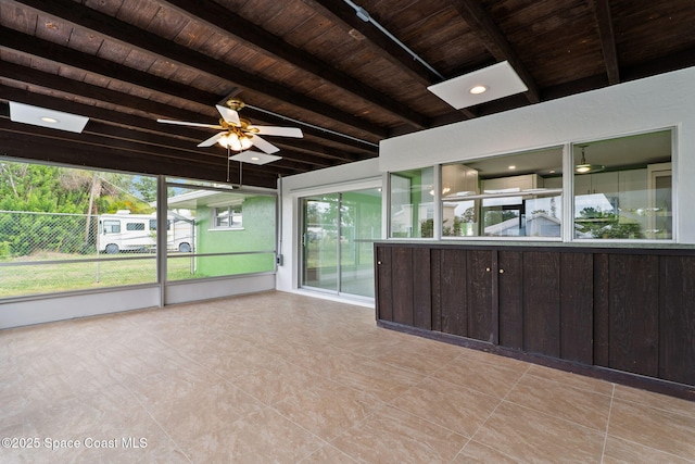 unfurnished sunroom with a ceiling fan