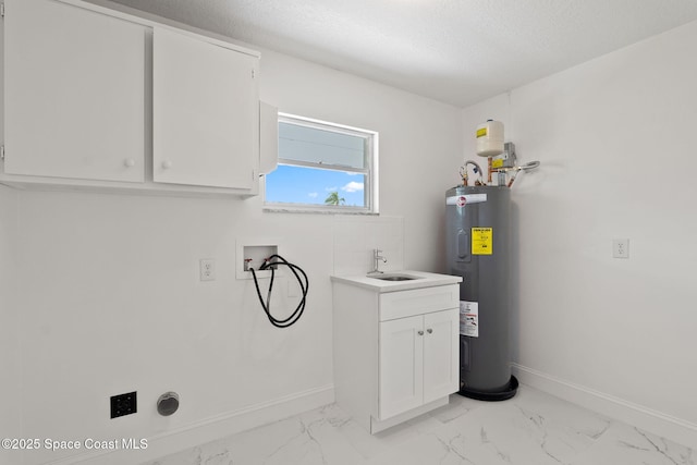 laundry room with water heater, hookup for a washing machine, baseboards, light marble finish flooring, and a textured ceiling