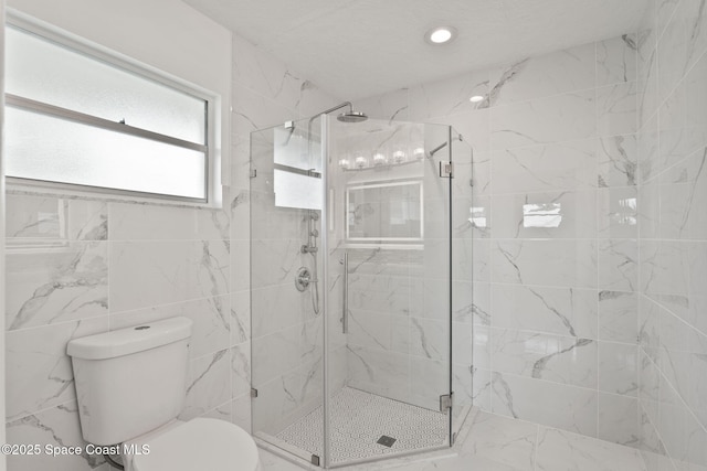 bathroom featuring toilet, a stall shower, and recessed lighting