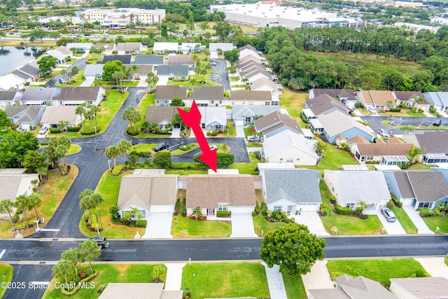 birds eye view of property with a water view and a residential view