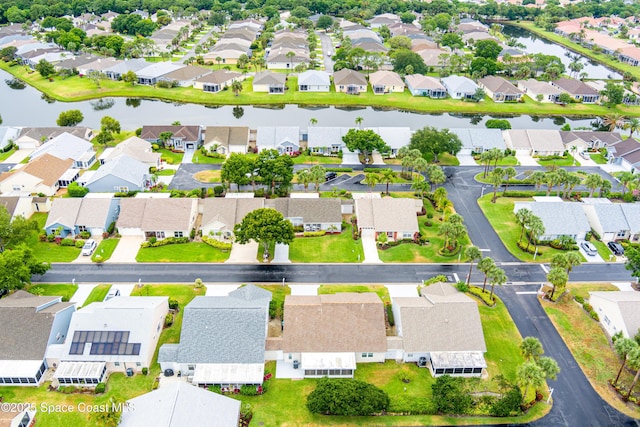 bird's eye view featuring a residential view and a water view