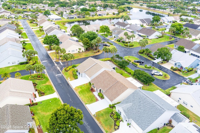 bird's eye view featuring a water view and a residential view