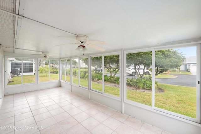 unfurnished sunroom with ceiling fan