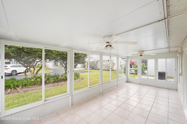 unfurnished sunroom with ceiling fan and a wealth of natural light