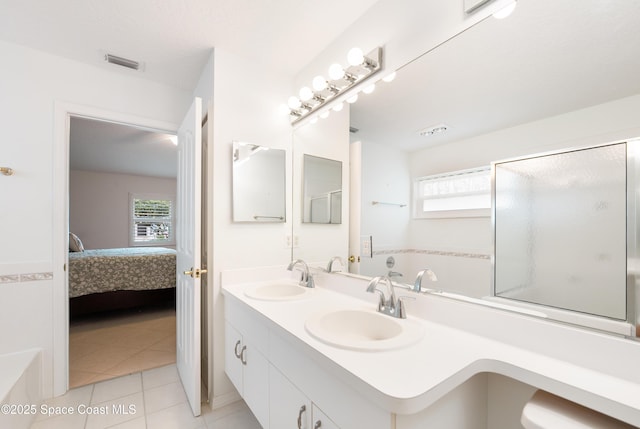 ensuite bathroom featuring visible vents, a healthy amount of sunlight, a sink, and a bath
