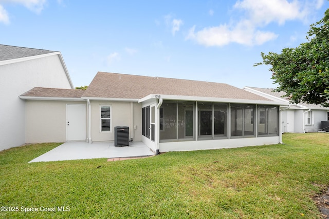 rear view of house featuring a lawn, a patio area, a sunroom, central air condition unit, and stucco siding
