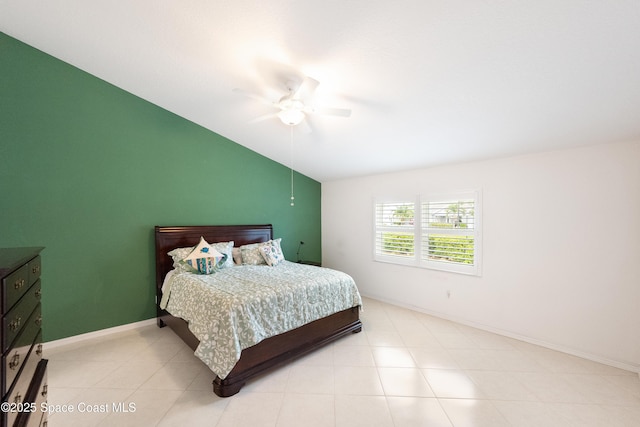 bedroom with ceiling fan, vaulted ceiling, and baseboards