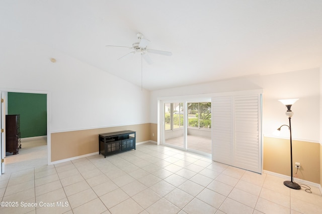 unfurnished living room featuring baseboards, ceiling fan, light tile patterned flooring, and lofted ceiling