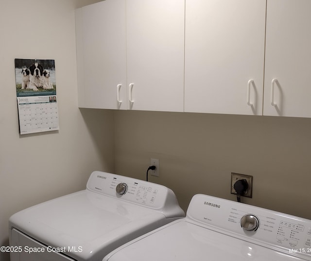 laundry area with washer and clothes dryer and cabinet space