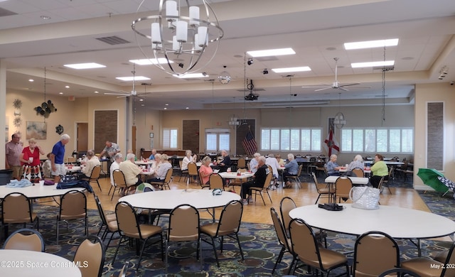 dining area featuring visible vents and ceiling fan with notable chandelier