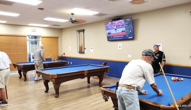rec room with billiards, a drop ceiling, a ceiling fan, and wood finished floors
