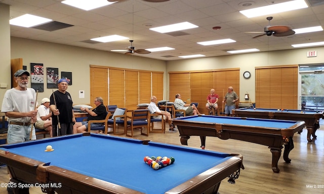 game room featuring billiards, ceiling fan, wood finished floors, and a paneled ceiling