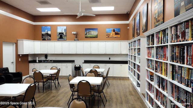 dining room with a ceiling fan, visible vents, a paneled ceiling, and light wood-style flooring