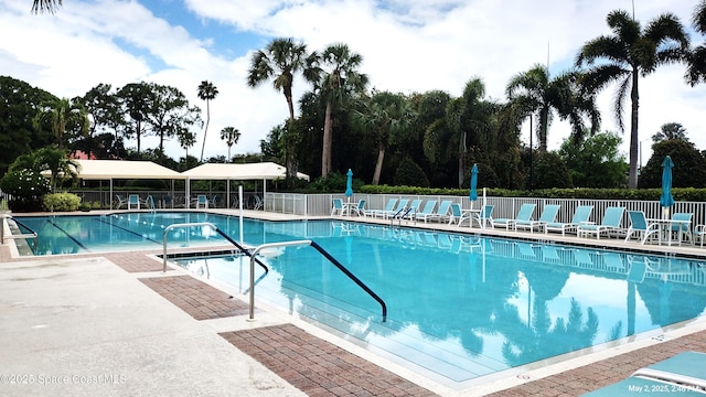 pool with fence and a patio area
