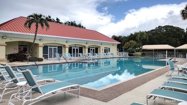 community pool featuring a patio area and fence