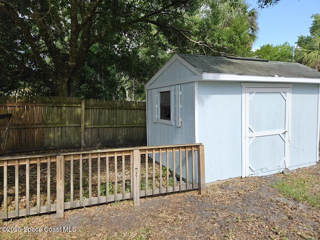 view of shed featuring fence