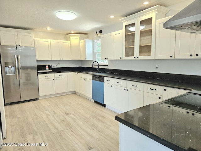 kitchen with stainless steel refrigerator with ice dispenser, light wood-type flooring, wall chimney exhaust hood, a sink, and dishwasher