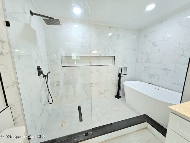 full bathroom featuring vanity, tile walls, recessed lighting, a freestanding bath, and a marble finish shower