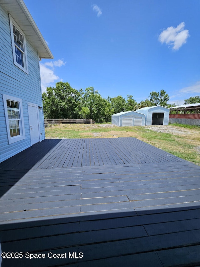 wooden deck with fence and an outbuilding