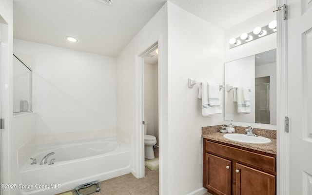 full bath featuring a garden tub, vanity, toilet, tile patterned floors, and a shower stall