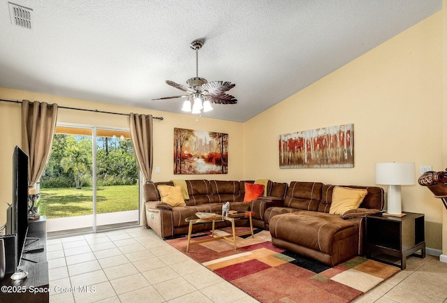 living area featuring a textured ceiling, a ceiling fan, light tile patterned floors, lofted ceiling, and visible vents