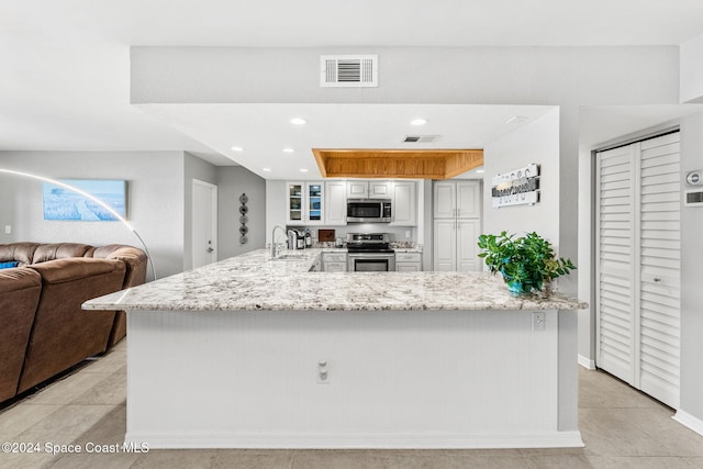 2207 Atlantic St Unit 825, Melbourne Beach, FL 32951 - kitchen with a sink, stainless steel appliances, light stone counters, and visible vents