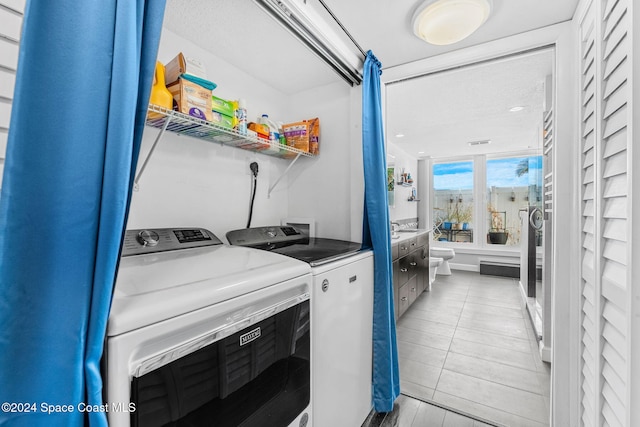 2207 Atlantic St Unit 825, Melbourne Beach, FL 32951 - washroom featuring laundry area, washer and clothes dryer, and visible vents