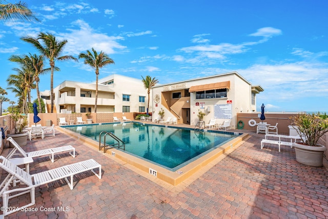 2207 Atlantic St Unit 825, Melbourne Beach, FL 32951 - community pool featuring a patio area and fence