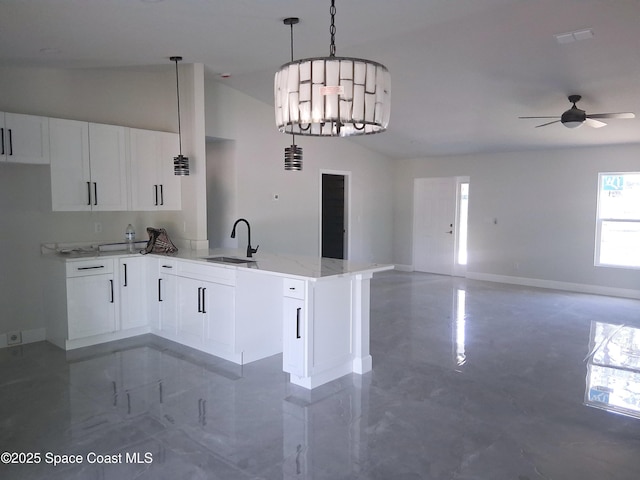 411 La Coco St SW, Palm Bay, FL 32908 - kitchen featuring a sink, a peninsula, baseboards, ceiling fan, and white cabinets