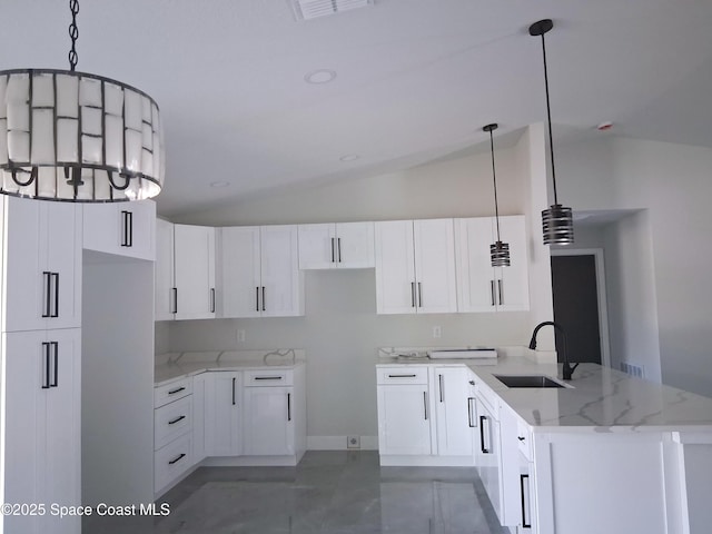 411 La Coco St SW, Palm Bay, FL 32908 - kitchen featuring a sink, lofted ceiling, light stone countertops, a peninsula, and white cabinetry
