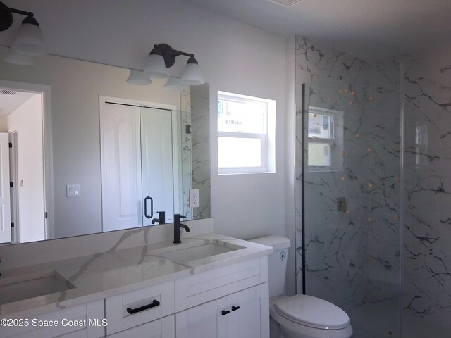411 La Coco St SW, Palm Bay, FL 32908 - full bath with a marble finish shower, vanity, and toilet