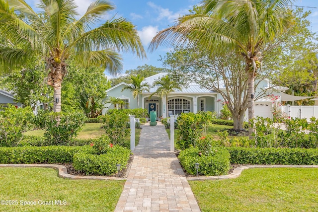 view of front of property with a front lawn, stucco siding, and fence