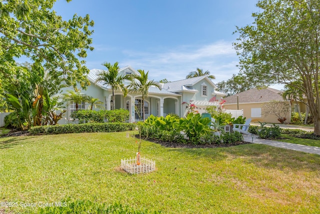 view of front of house featuring stucco siding and a front yard
