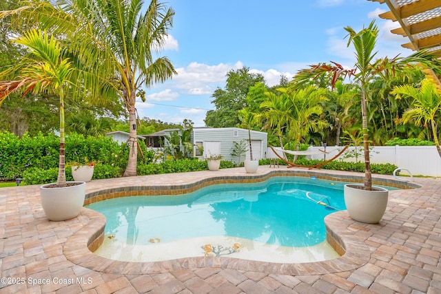 view of pool featuring fence, a fenced in pool, and a patio area