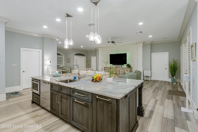 kitchen featuring dishwasher, crown molding, ceiling fan, and a sink